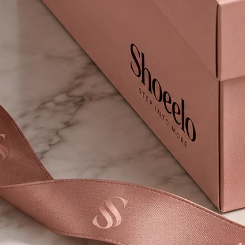 Blush satin ribbon printed with the S monogram
